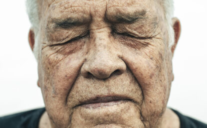 Close-up portrait of an older man with his eyes closed